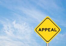 Appeals Showdown: Law And Order Vs Activism A yellow diamond-shaped sign with the word 'APPEAL' against a blue sky