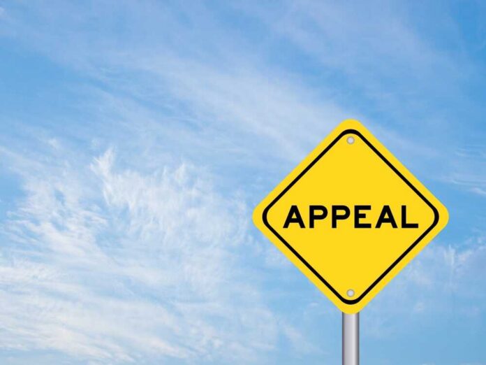 A yellow diamond-shaped sign with the word 'APPEAL' against a blue sky