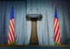 Press Room Shock: Sudden Exit Raises Stakes Press podium with the White House sign and an American flag in the background