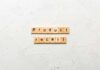 Deadly Brake Flaw Triggers Massive Recall Wooden letter tiles forming words on a white textured surface