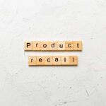 Wooden letter tiles forming words on a white textured surface