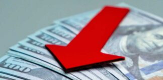 Red downward arrow on U.S. dollar bills