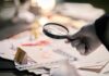 Foul Play Twist In Vanished Mom Case Gloved hand holding a magnifying glass over scattered forensic documents