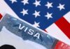 Close-up of a US visa on a background of the American flag