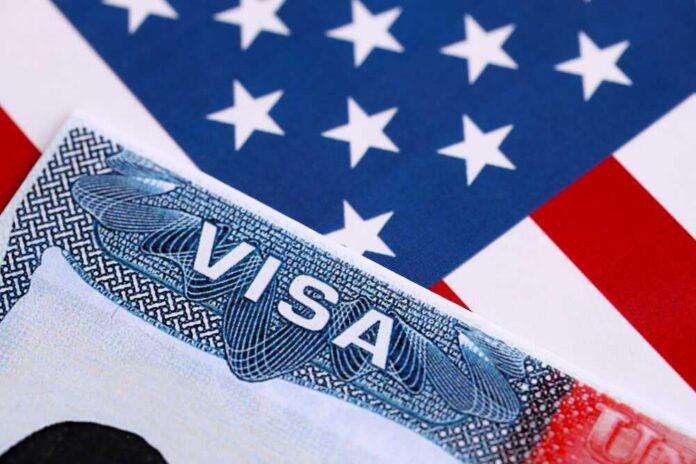 Visa,To,The,Usa,And,The,Flag,Of,The,United Close-up of a US visa on a background of the American flag
