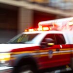 Ambulance with flashing lights speeding through a city street