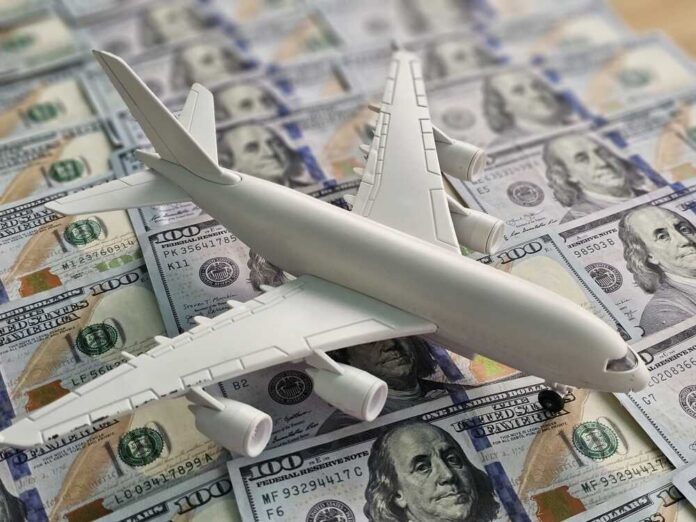 Airplane,Model,Placed,On,Hundred,Dollar,Bills,In,A,Display