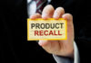 Hand holding a product recall card