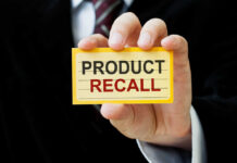 Metal In Dog Food? Nationwide Recall Hand holding a product recall card
