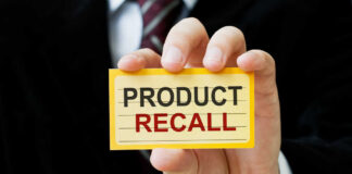 Hand holding a product recall card