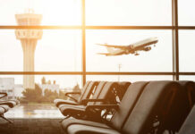 Shock Airport Grab: Swalwell’s Devices Seized View of an airport terminal with an airplane taking off in the background