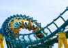 Beloved Park Shutters — What Vanishes Next? Roller coaster train twists through a teal and yellow loop