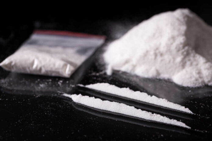 Plastic,Packet,,Two,Lines,And,Pile,Of,Cocaine,On,Black Cocaine