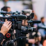 Video cameras on tripods at a media event