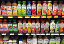 Bottled drinks on store shelves, including Naked and Bolthouse brands.