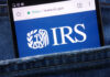GOP Hurls IRS Grenade at Longtime Charity Smartphone showing IRS website in a denim pocket
