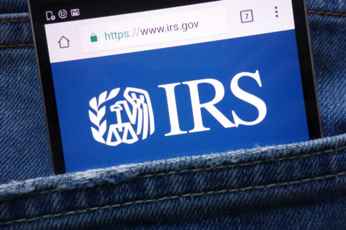 Konskie,,Poland,-,May,19,,2018:,Irs,(internal,Revenue,Service) Smartphone showing IRS website in a denim pocket