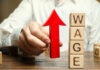 TRUTH: Lib City’s Pay Hike Backfires stopwatch over abstract globe with ripple lines