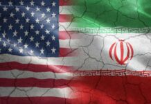 Voters Revolt: Iran War Backfires Flags of the United States and Iran blended together with a cracked texture