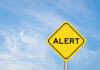 STUNNING: Price Blows Past Old Record Yellow alert sign against a blue sky