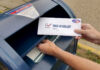 Ballots in Dumpster? Feds Drop Hammer Hands mailing a ballot envelope into a blue mailbox
