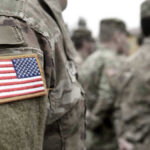 Moon War Warning From America’s Top General U.S. soldiers in camouflage uniforms with American flag patch.