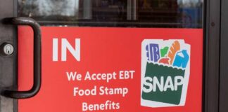 Sign on a store door indicating acceptance of EBT food stamp benefits