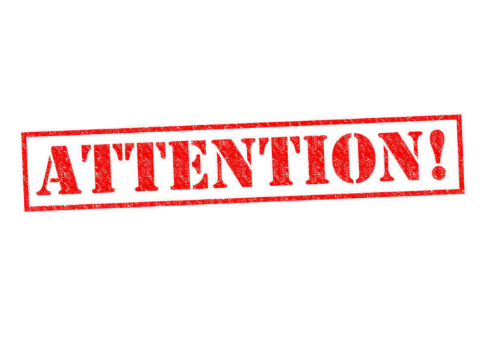 shutterstock_214851508 Red attention stamp on white background