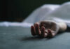 Lib Newspaper Exec Shot Dead Dead persons hand lying on a gray surface