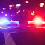 Police car with flashing red and blue lights at night