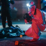 College Nightmare: Five Shot Outside Residence Hall Forensic investigator examines crime scene at night.