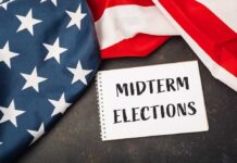 ELECTION: 80-Year-Old Steamrolls ‘New Blood’ Revolt American flag and a notebook with 'MIDTERM ELECTIONS' written on it
