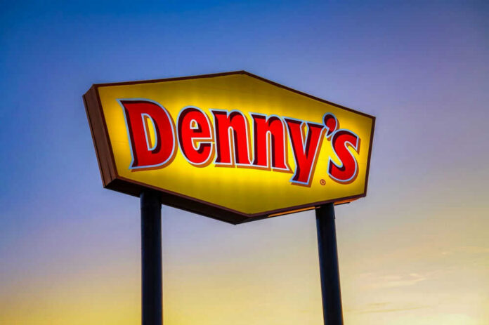 Dennys sign illuminated against a twilight sky