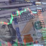 US dollar bills with overlaid stock market charts