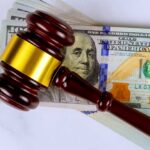 IRS Gutted, Billions Vanish Judge’s gavel on a stack of U.S. hundred-dollar bills