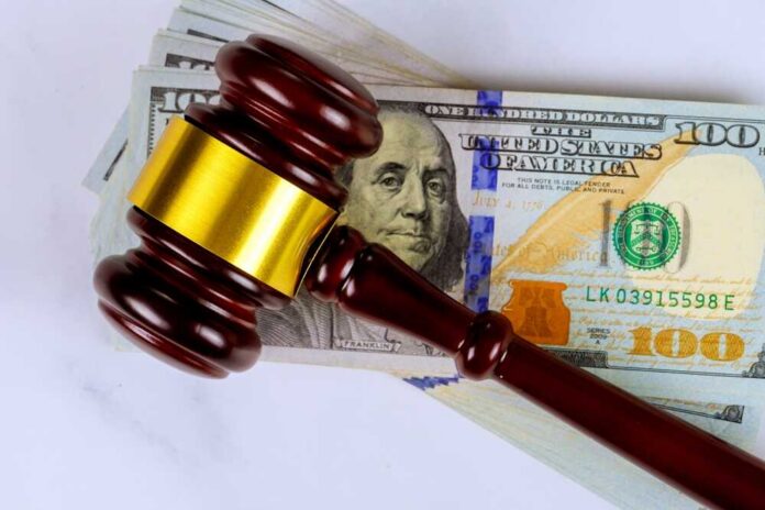 Judge’s gavel on a stack of U.S. hundred-dollar bills