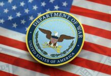 Seal of the Department of War on an American flag background