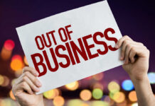 NEW: 25 Stores Axed Hands holding an out of business sign