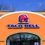 Exterior view of a Taco Bell restaurant with a colorful sign