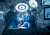 Josh Kline and Dontrelle Inman performing surgery with a medical team in an operating room