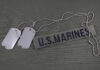Marine Indicted in Death Dog tags beside a U.S. Marines name tape on olive fabric