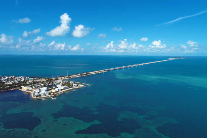 Aerial,View,Of,Famous,Bridge,And,Islands,In,The,Way Aerial view of a coastal area with a long bridge extending over turquoise waters