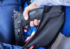 Birthday Gun, Dead Kids – What’s Next? A hand holding a gun inside a backpack