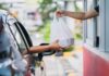 Drive-Thru Disrupted By Gas-Station Grub Customer receives a takeout bag at a drive-thru window
