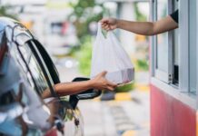 Drive-Thru Disrupted By Gas-Station Grub Customer receives a takeout bag at a drive-thru window