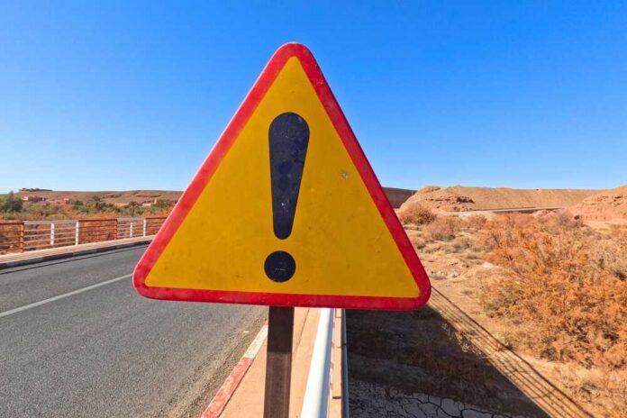 Yellow,Danger,Warning,Sign,,Exclamation,Mark,Sign Triangular warning road sign with exclamation mark on a rural highway