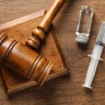 Ventilator Aftermath Triggers Death-Row Pause A wooden gavel next to a syringe and a vial on a wooden surface