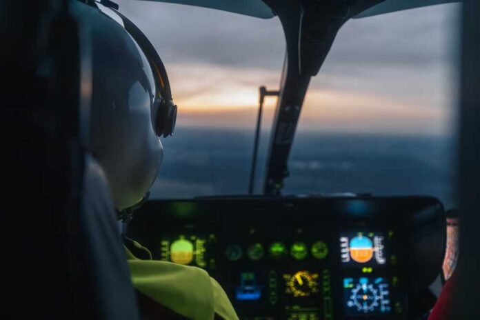 Pilot's view from a helicopter cockpit during sunset