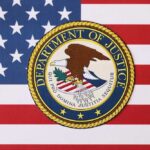 DOJ Blitz Nails 16 For Illegal Voting Department of Justice seal on American flag background