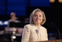 Hillary’s Bold Midterm Play Drops Hilary Cawthorne at a podium with microphones
